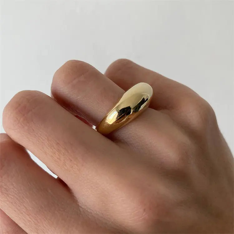 Sleek Gold Stainless Ring - Euro-American Style worn on finger, showcasing its modern minimalistic design.